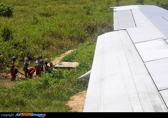 I think this can only happen in Indonesia, children bathing right next to the runway Boeing 737-200