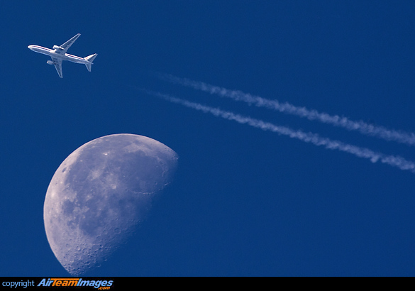 Contrail passing the moon Boeing 767-323/ER