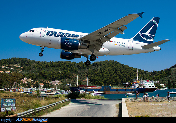 coming in very low over the beach and the road Airbus A318-111
