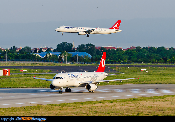 Flights are approaching on a crossing runway compared to the departing aircraft. In the back is TK A321 is TC-JRR. Airbus A320-200