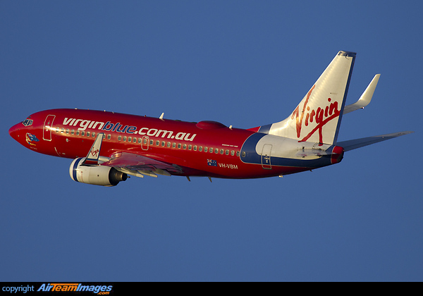 Cranking into the left turn from runway 15 a Virgin 737 departs on a typical blue sky Cairns morning. Boeing 737-76N