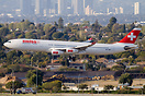 Swiss Airbus A340-300 landing in LA seen in front of the LA CBD