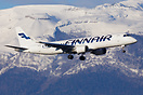 Finnair Embraer 190 landing at Geneva airport, seen in front of a wint...