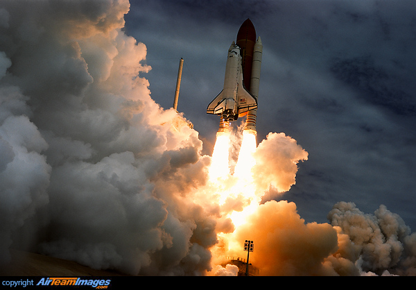 The last space shuttle launch captured with the same photo technology as used to capture the first launch. The one and only slide film shot for this launch. The last slide of the one and only slide camera at the last space shuttle launch. I put a Minolta X-700:50mm lens & Fuji Velvia 50 (F/8@1/1000) on the pad. Secured to the ground with six 9 inch stakes and three 30 lb sandbags at each leg of the tripod. Camera was fired by the sound of the main engine start and shot all 36 frames with this being the last complete frame. Despite being a dull overcast day, the film captured a better dynamic range than digital hence resulting in richer color prints. Space Shuttle Atlantis
