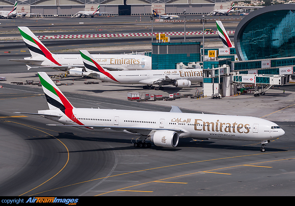 Taxing inboud for parking, with a company A340-500 and A380-800 parked at the gate. Boeing 777-31H/ER
