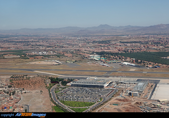 An aerial view of Marrakesh Menara Airport. In the foreground, the terminal is in the process of being extended to cope with increasing traffic. On the opposite side of the runway is the military airbase with various aircraft of the Moroccan Air Force based there. Marrakesh Menara Airport