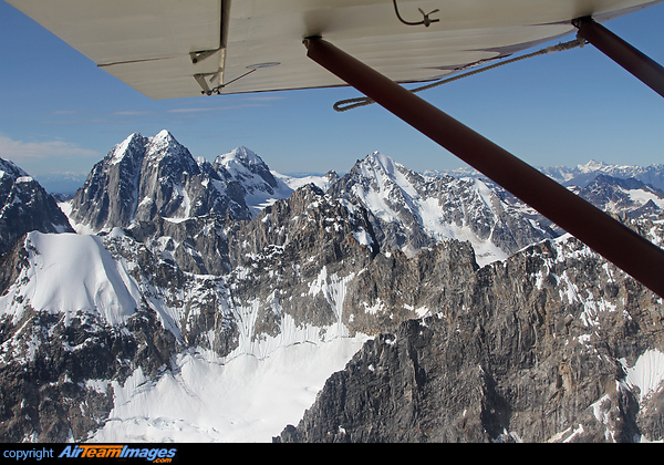 Mountain flying over Denali National Park in Alaska. Piper PA-22-150