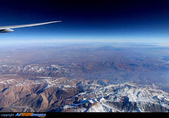 Enjoying the panorama from high above the snow-capped mountains of north-west Iran, enroute from Dubai to Istanbul. Taken from the last row in the 777-300, so far back that you can just see the start of our own contrail. Boeing 777-3F2/ER
