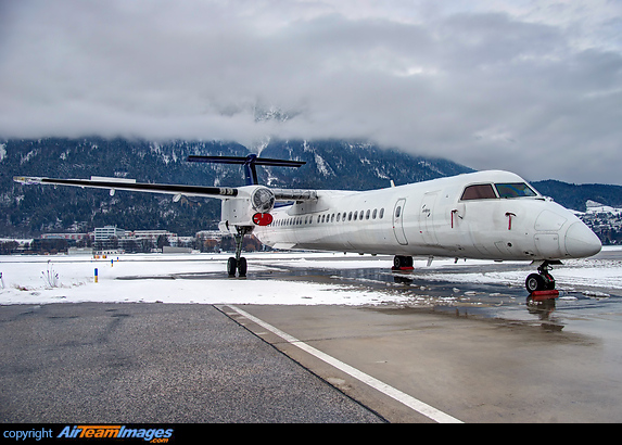 delivered just one month ago, now with a broken wing and without props resting at the apron in Innsbruck Bombardier Dash 8-402Q