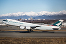 The Alska range dominates the view as a Cathay 748 freighter departs i...