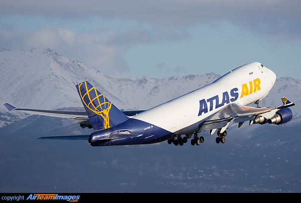 An Atlas 744F blasts off Rwy 15 at ANC giving a chance to photograph the great background as she climbs away. Boeing 747-47UF/SCD
