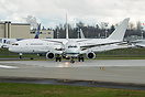 Head on shot of Alaska Airlines 737-900ER with a Boeing 787 BBJ in the...