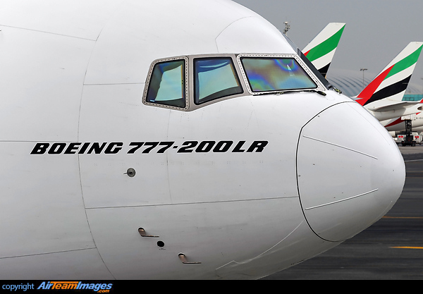 Closeup nose shot-cockpit shot of the 777-200LR taxing out of DXB with other 777 heavies lines up in the bacground Boeing 777-21H/LR