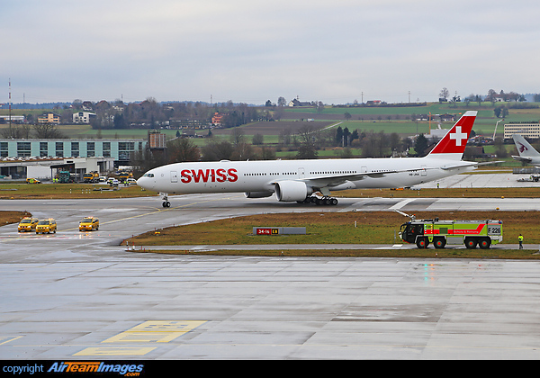 about to receive a water canon salute as she is being escorted with three follow-me cars Boeing 777-3DE/ER