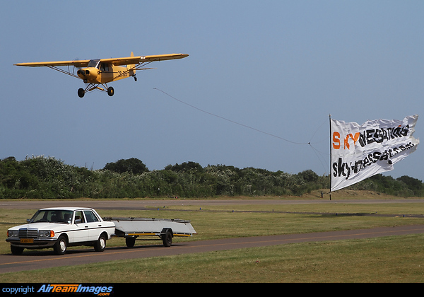 Just after the release of the Sky Messaging Banner. In the foreground is the banner recovery vehicle and trailer. Piper PA-18A-150 Super Cub