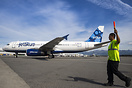 A JetBlue wing walker keep a close on on the progress of an Airbus A32...