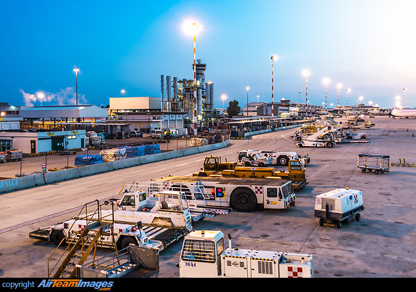Cargo ramp including all the different vehicles and infrastructure very shortly before sunrise. Milan Malpensa Airport