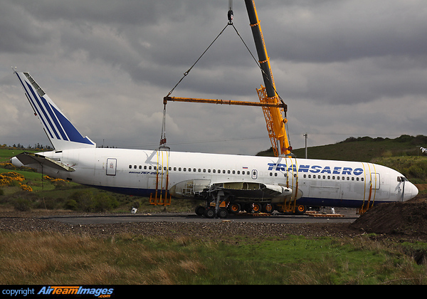 This Boeing 767 was removed from Shannon Airport and floated round the coast by barge to Enniscrone, County Sligo. It is seen at the end of its journey being lifted from a flatbed and swung into position. It will now be converted into a hotel. Boeing 767-216/ER