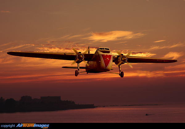 Bristol Freighter on final approach against a colourful sunset sky. Composite image. Bristol Freighter Mk31E
