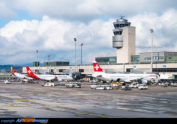 Terminal A pier with apron control tower. Next to the Swiss are Helvetic Airways E190LR HB-JVQ and TAP Express E190LR CS-TPV. Airbus A321-111