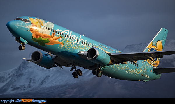 With only a few months of life left till retirement Alaskan Airlines special scheme 737 called "Magic of Disneyland" or affectionately known as Tinkerbell departs against a dark snowy Alaskan sky. Boeing 737-490