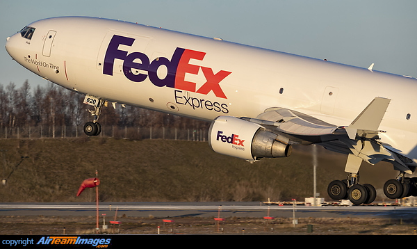 As shown by the windsock a 5 Knot tailwind makes hard work for a very heavy Fedex MD-11 off runway 33 at Anchorage headed for Beijing. McDonnell Douglas MD-11F