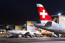 Parked at the terminal with ground equipment arranged around the aircr...