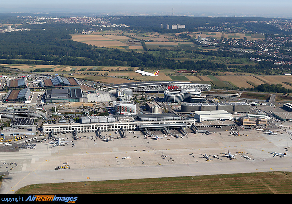 Stuttgart airport with all terminals, the fair, the large parking garage, the tv tower in the distance and a Germanwings Airbus taking off. Stuttgart Airport