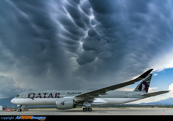 Some impressive mammatus clouds from a nearby thunderstorm serve as the frame for this one Airbus A350-941