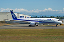 ANA's latest 787-9 entering active runway with Boeing factory in backg...