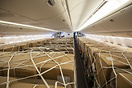 Thousands of masks and gloves are loaded onto passenger seats