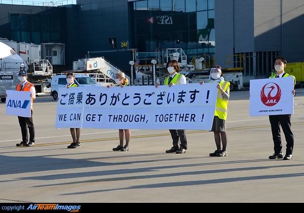 ANA and JAL staff united holding a message We can get through, together! We can get through,together!