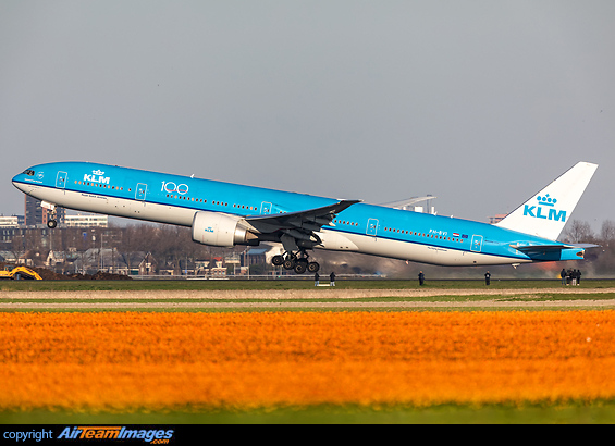 A KLM boeing 777-300ER leaving Dutch soil as she is being watched by many spotters and enthousiasts, with a nice background of an orange flower field in spring Boeing 777-306/ER