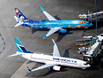 A regular and Frozen-themed 737 parked side-by-side in Vancouver