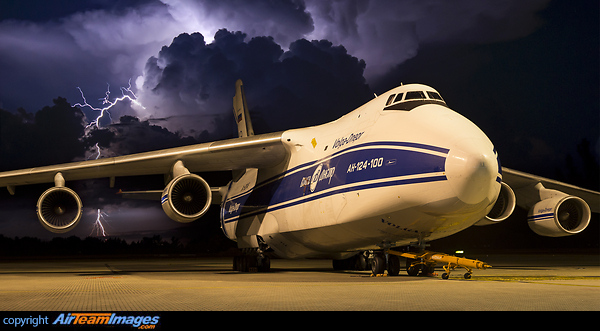 The stormy tropics come to life as a tropical thunderstorm lights up the night sky over a visiting Antonov 124 in Cairns. Antonov An-124-100 Ruslan