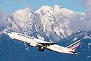 Air France's 777 roars past YVR's classic mountain backdrop.