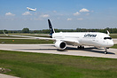 Lufthansa Airbus A350-941 vacating runway 26R with a Finnair A321 taki...