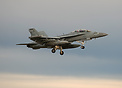 US Navy F18 Growler landing in a beautiful sunset dusk sky