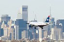 US Airways Airbus A319 on final for Runway 22 in front of the great sk...