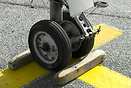close up of nose gear with chocks in place