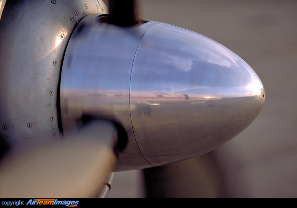 close-up of the spinning No. 2 engine propeller. This photograph was taken from the open L1 door during taxing. Our own fuselage and clouds in the sky are clearly reflected beautifully by the polished metal. L-1049H/01 Super Constellation