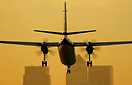 VLM's Fokker 50, Island of Jersey, OO-VLL, drops into LCY at sunset. T...