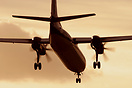 VLM's Fokker 50 OO-VLF approaches London City airport at sunset.